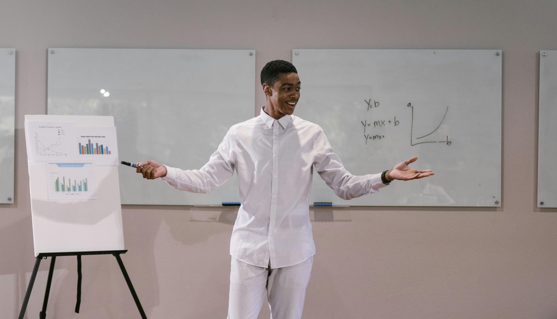 A Man in White Long Sleeve Presenting Report in the Meeting Room