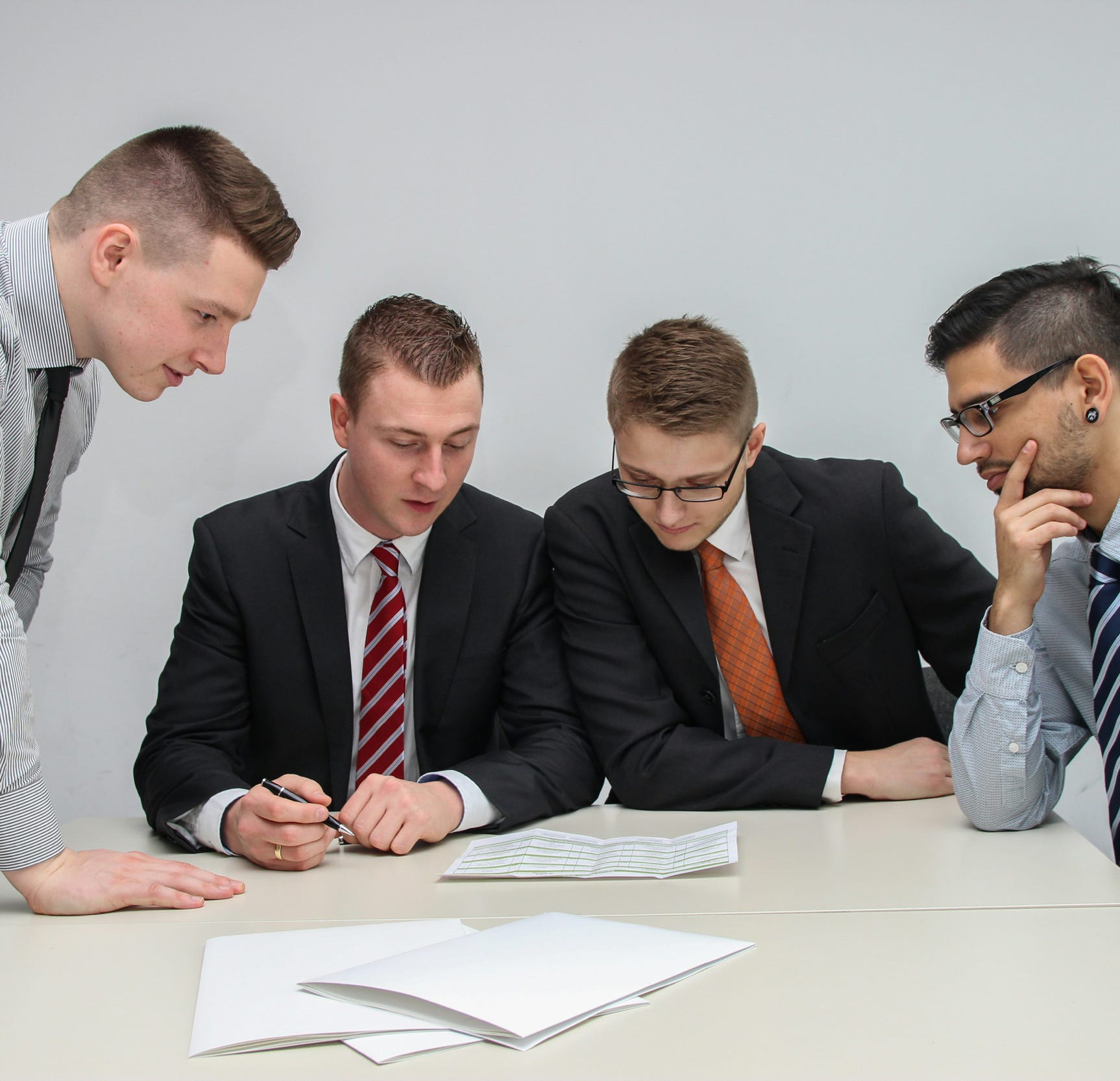 Positive young multiracial guys demonstrating thumbs up sign at camera