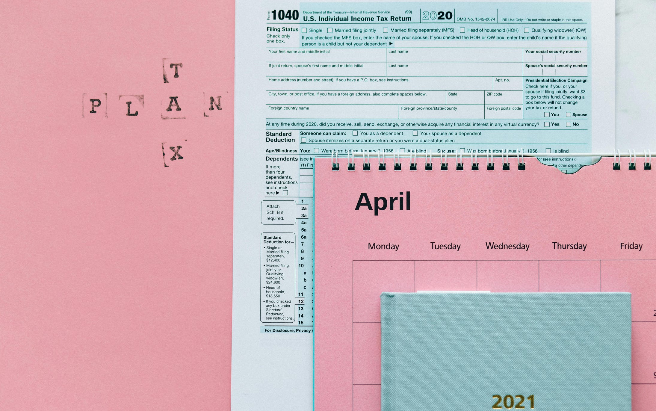 Tax Return Form and 2021 Planner on Pink Surface